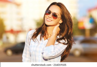 Fashion lifestyle portrait pretty woman in the sunglasses posing in the city summer, evening sunset sunny light, street fashion