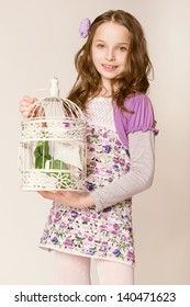 Fashion Little Girl With Birdcage. Studio Photo