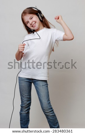 Fashion little girl with headphone singing