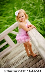 fashion little girl in tutu swimsuit have a fun outdoor