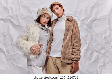 fashion lookbook concept, interracial models in winter attire posing on white textured background - Powered by Shutterstock