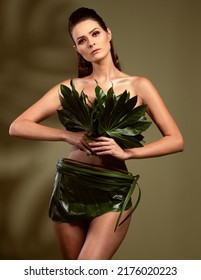 Fashion Magazine Model Poses In Clothes Made Of Natural Elements, Green Leaves, Spring Concept