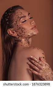 Fashion makeup concept. Beauty, fashion gold concept. Portrait of a beautiful girl model with gold on her skin.