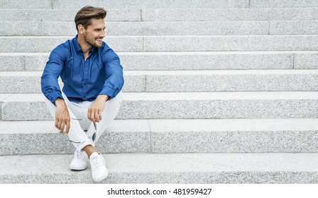 Fashion Male Model Sitting And Smiling