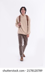 Fashion Model. Full Body Young Man With Sweater Hoodie ,with Backpack Posing Walking In Studio