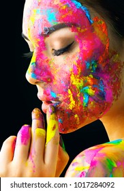 Fashion Model Girl colorful face paint. Beauty fashion art portrait, beautiful woman with painting smears, abstract makeup. Vivid paint make-up, bright colors. Multicolor creative make-up