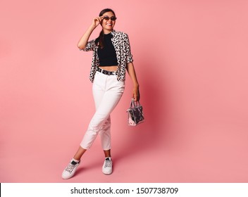 Fashion Model Girl Full Length Portrait Isolated On Pink Background. Beauty Stylish Brunette Woman Posing In Fashionable Clothes In Studio. Casual Style, Beauty Accessories. High Fashion Urban Style