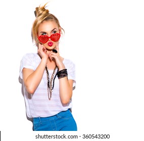 Fashion Model Girl Isolated Over White Background. Beauty Stylish Blonde Woman Posing In Fashionable Clothes And Heart Shaped Sunglasses. Casual Style With Beauty Accessories. High Fashion Urban Style