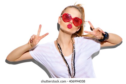 Fashion Model girl isolated over white background. Beauty stylish blonde woman posing in fashionable clothes and heart shaped sunglasses. Casual style with beauty accessories. High fashion urban style