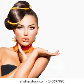 Fashion Model Girl Portrait with Yellow and Orange Makeup. Creative Hairstyle. Hairdo. Make up. Beauty Woman isolated on a White Background