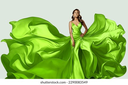Fashion Model in Green Dress with flying Silk Fabric. Beautiful Girl in Satin Evening Gown over White. Happy Woman in Spring Skirt fluttering on Wind - Shutterstock ID 2290083549