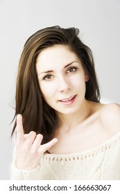 Fashion Model Head Shot Portrait Wearing White Sweater Making Rock And Roll Sign Smiley Face