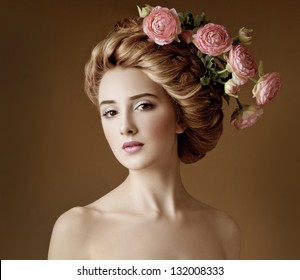 Fashion Model With Large Hairstyle And Flowers In Her Hair.