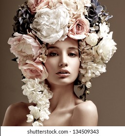 Fashion Model With Large Hairstyle And Flowers In Her Hair.