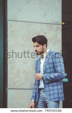 Similar – Thoughtful young man sitting on an urban bench