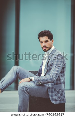 Similar – Thoughtful young man sitting on an urban bench