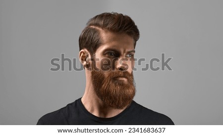 Fashion model with stylish hair and beard. Man with long beard and mustache on serious face isolated on grey background. Barber fashion and beauty.