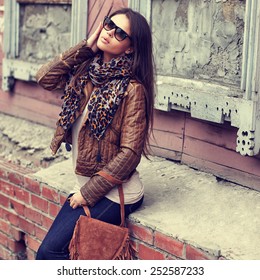 Fashion Model With Sunglasses, Leather Jacket, Scarf, And Handbag