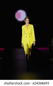 Fashion Model Walks The Runway In Yellow Pantsuit 