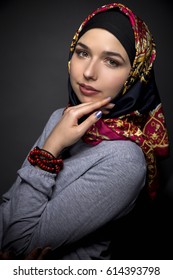 Fashion Model Wearing Hijab For Conservative Modern Clothing Mostly Associated With Muslims, Middle Eastern And East European Culture.  The Outfit Depicts The Traditional Headscarf In Vogue Style.