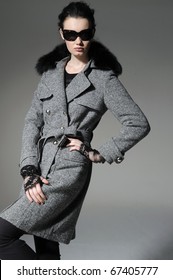 Fashion Model In Winter Fur Coat Clothes Posing In The Studio