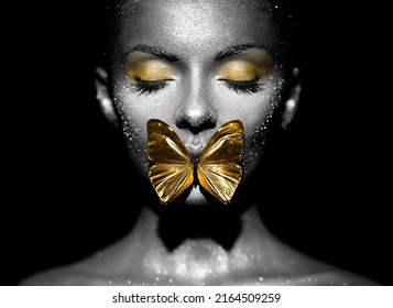 Fashion model woman in bright sparkles and lights posing in studio. Portrait of beautiful sexy woman with butterfly. Art design glitter glowing make up. Black and white photography