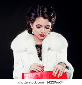 Fashion Model Woman In Fur Coat Open Shopping Bag. Isolated On Black Background. Retro Girl.