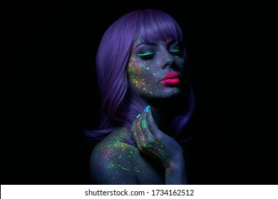 Fashion Model Woman In Neon Light Bright Fluorescent Makeup, Long Hair, Drop On Face. Beautiful Model Pink Hair Girl Colorful Make-up, Painted Skin, Body Art Design Ultraviolet