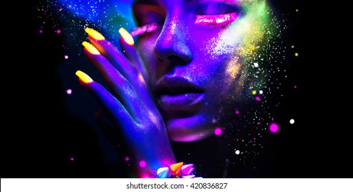 Fashion model woman in neon light, portrait of beautiful model with fluorescent make-up, Art design of female disco dancers posing in UV, colorful make up. Isolated on black background