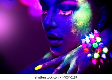 Fashion model woman in neon light, portrait of beautiful model girl with fluorescent powder make-up, Art design of female disco dancer posing in UV, colorful make up. black background