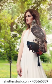 Fashion Model Woman Wearing White Dress with Bird Outdoors