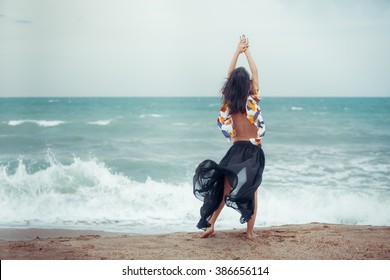 fashion outdoor photo of beautiful woman with dark hair  relaxing on summer beach