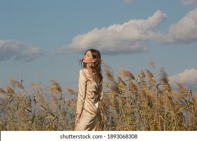 Fashion Outdoor Portrait Of Woman In Beige Silk Satin Long Dress. 