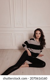 Fashion Photo Of Beautiful Woman With Dark Hair In Cozy Cardigan Posing In Studio