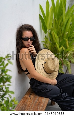 Similar – Brunette surfer woman with top and bikini holding surfboard