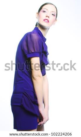 Fashion photo, a model is posing over grey background
