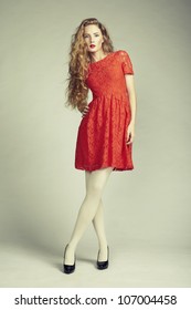 Fashion Photo Of Young Magnificent Woman In Red Dress. Studio Photo