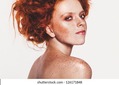 Fashion photo of a young woman with red hair. Close-up