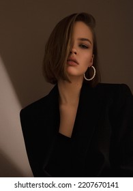 Fashion photography. A beautiful girl in a black jacket with a dramatic light. Imitation grain film photography. High quality photo