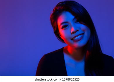 Fashion Portrait Asian Woman With Creative Lighting With Smile Face And Happy Blue Background Asia Girl In Blue And Red Light Beautiful Female Has Long Hair Trendy Color Background And Copy Space