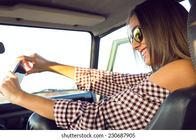 Fashion Portrait Of Beautiful Girl Taking Selfie With Smartphone In The Car. 