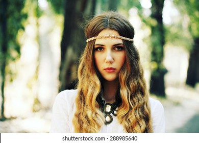 Fashion Portrait Of Beautiful Hippie Young Woman Wearing Boho Chic Clothes And Summer Hat Outdoors. Soft Warm Vintage Color Tone. Artsy Bohemian Style.