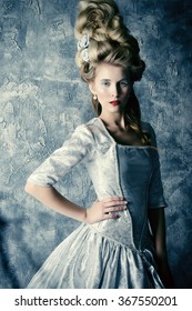 Fashion Portrait Of A Beautiful Woman In A Luxurious Medieval Dress And High Hairdo In Vintage Style. Baroque And Renaissance Style. Historical Dress, Hairstyles History. 