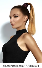 Fashion Portrait Of Beautiful Young Woman With Ponytail Hairstyle. Beauty Shot Of Sexy Girl On White Background. Pony Tail Straight Hair, Catwalk Black Eyeliner Makeup On Model Face