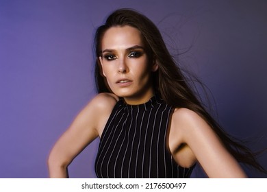 Fashion Portrait Of A Brunette With Long Hair And 90s Style Makeup Through A Crystal Filter, Overalls And A Red Leather Belt On A Purple Background