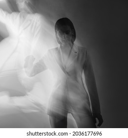 Fashion Portrait With The Effect Of Blurring In Motion At A Long Shutter Speed, Distortion Of The Model's Face. Alter Ego, Soul Movements, Concept. Young Stylish Woman In A White Jacket