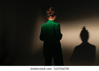 Fashion Portrait Of Elegant Trendy Woman In Red Down Jacket. Neon Light, Sunglasses, Studio Shot