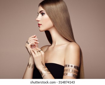 Fashion portrait of elegant woman with magnificent hair. Blonde girl. Perfect make-up. Girl in elegant dress. Flash tattoo gold - Shutterstock ID 314874143