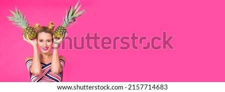 Fashion portrait funny woman with pineapple banner over pink background with copy space and place for advertising