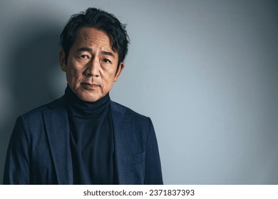 Fashion portrait of a handsome Asian middle-aged man. - Powered by Shutterstock